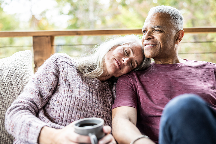 Older couple sitting together outdoors