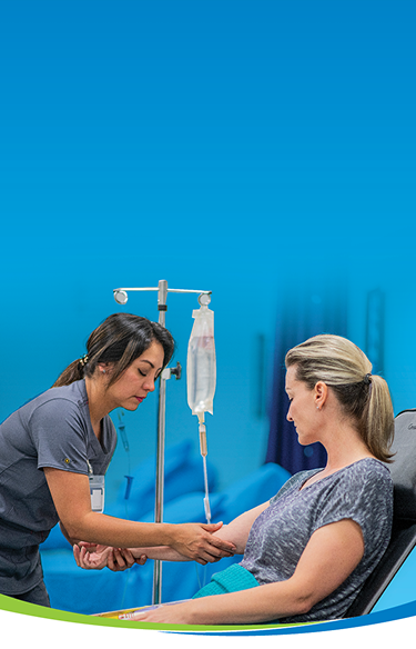 Nurse administering intravenous infusion to a patient